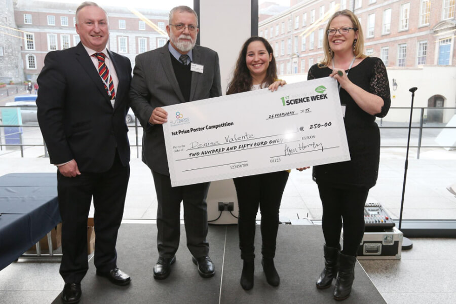 Student winner of a PhD poster competition at Brazil Ireland Science Week is awarded a prize by the Brazilian Ambassador to Ireland, and the Irish Universities Association